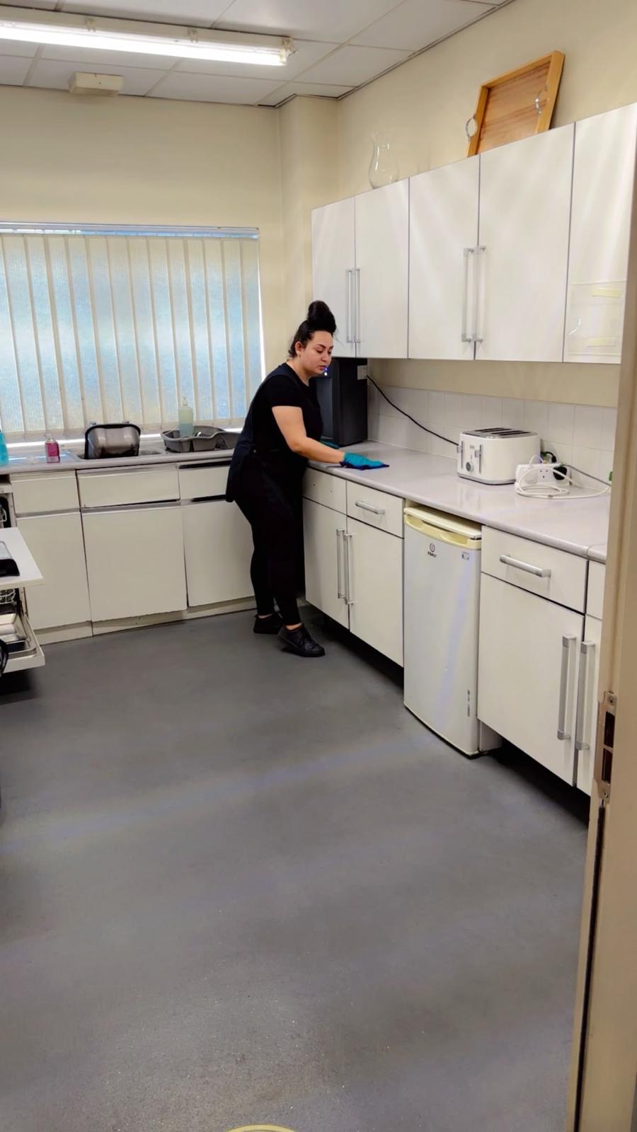 A Zeal FM operative cleaning a staff kitchen in a commercial office